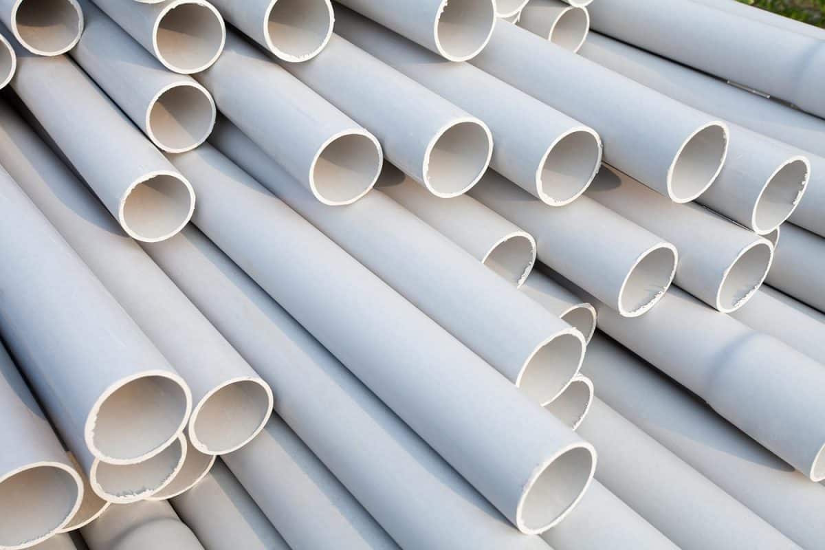Heap of PVC pipes stacked at construction site