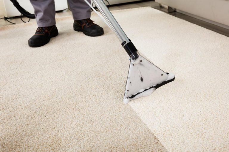 A person cleaning carpet with a vacuum cleaner, How To Stop Foam In Carpet Cleaner