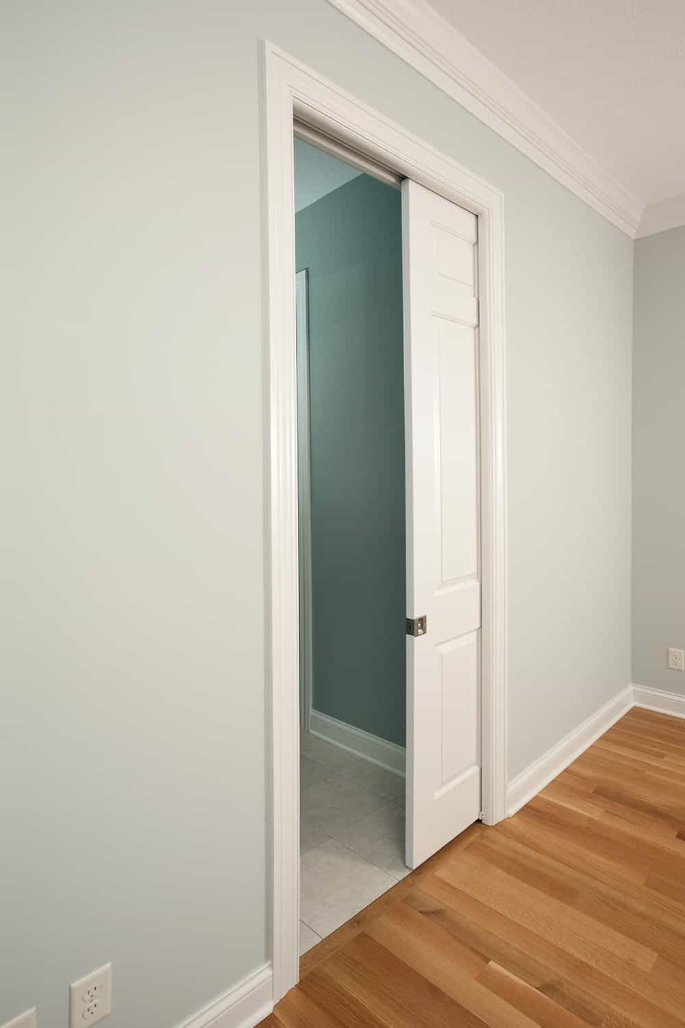 A new pocket door in a house bedroom entrance to bathroom