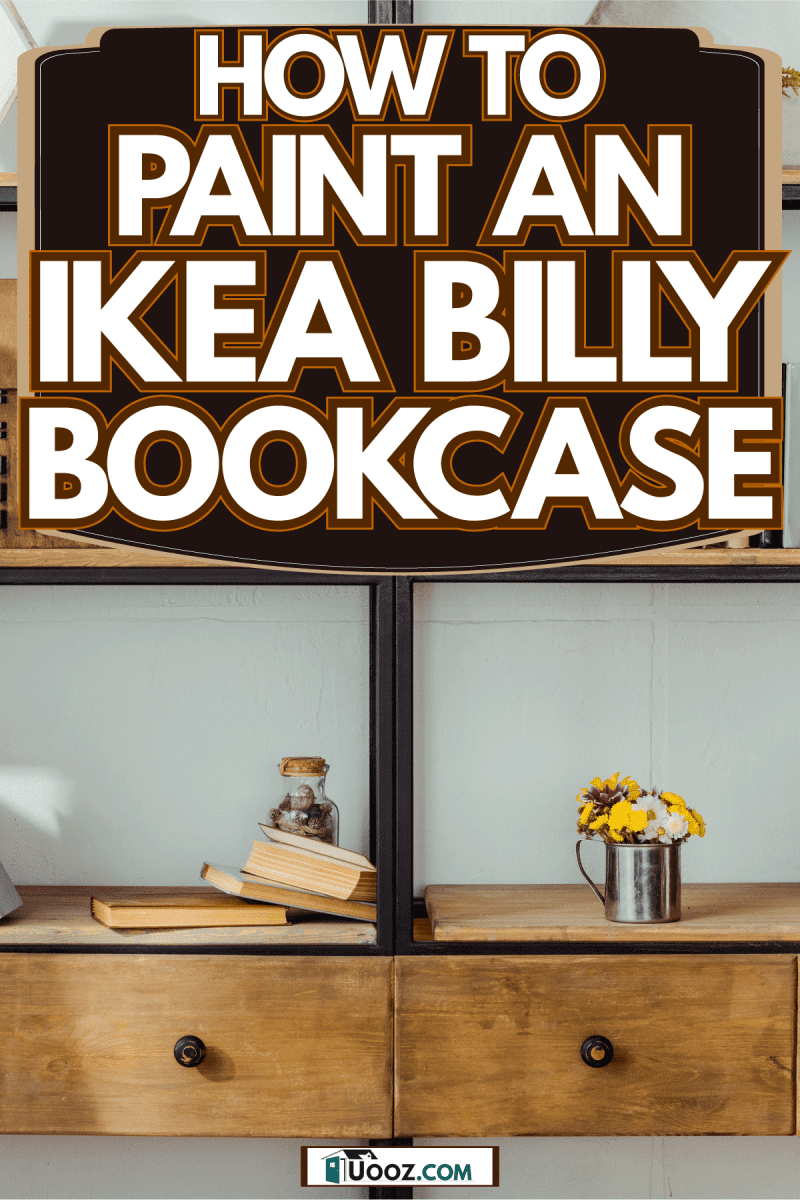 A huge bookcase inside a study room and a small reading chair with a book holder on the side, How To Paint An IKEA Billy Bookcase
