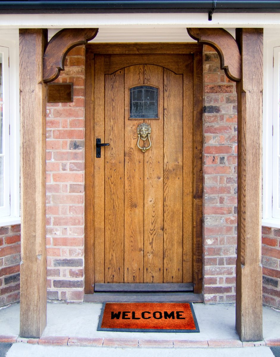 Old Oak Door with Welcome Mat.