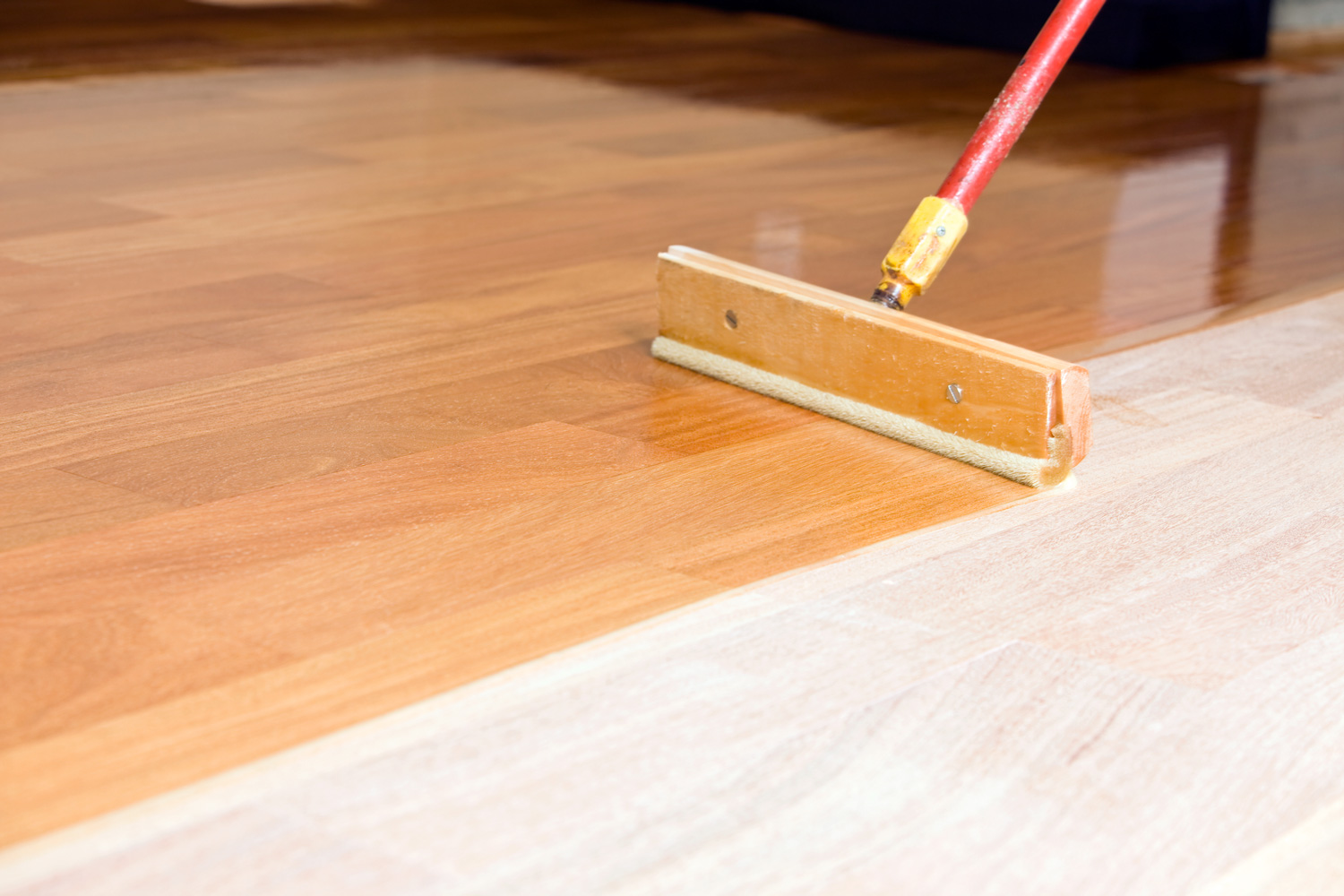 queegee Style Brush Applying Clear Polyurethane to Hardwood Floor 