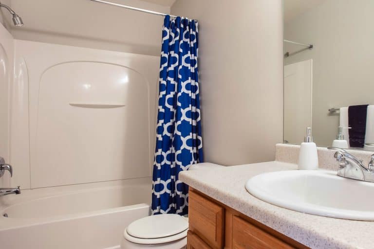 A blue patterned shower curtain for the bathtub, How To Cover Bathroom Wall Tiles