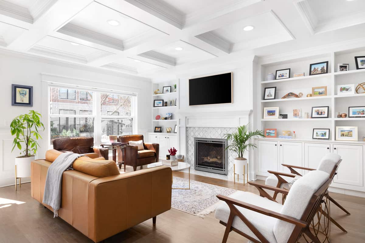 A luxurious white living room with a coffered ceiling