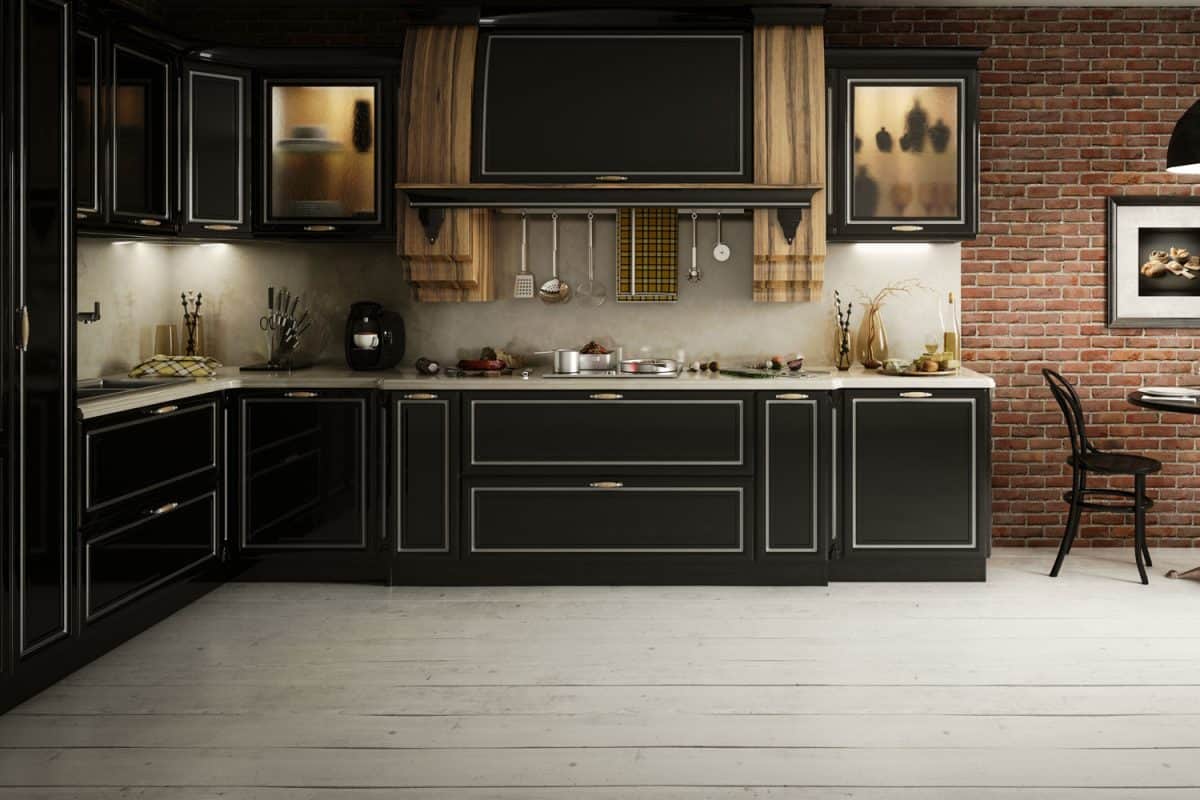 Black modern cabinets and cupboards inside a rustic kitchen with white flooring