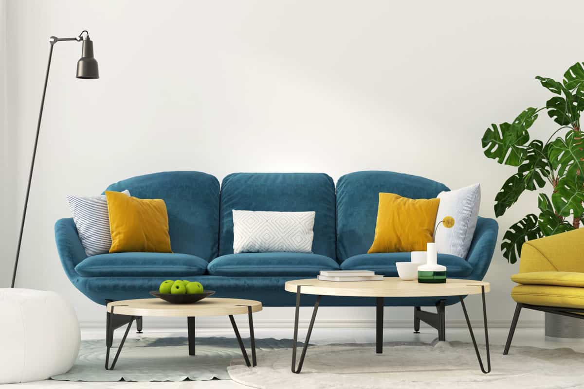 Colorful interior of living room with a blue sofa and a yellow armchair