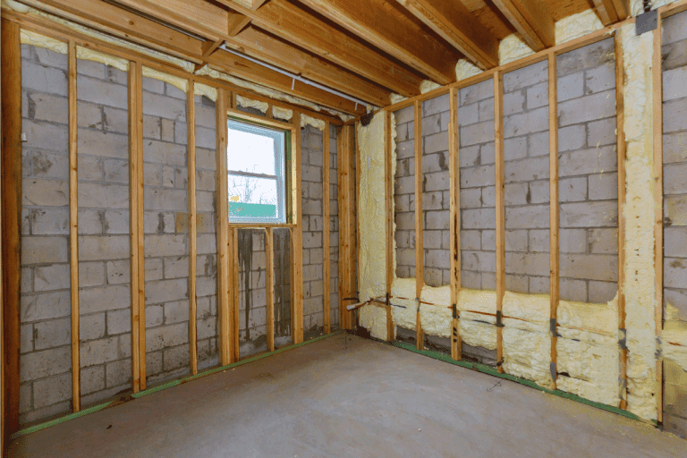 House-in-unfinished-under-construction-in-insulation-foam-the-wall-of-a-basement.-Exposed-Insulation-In-Basement—What-To-Do
