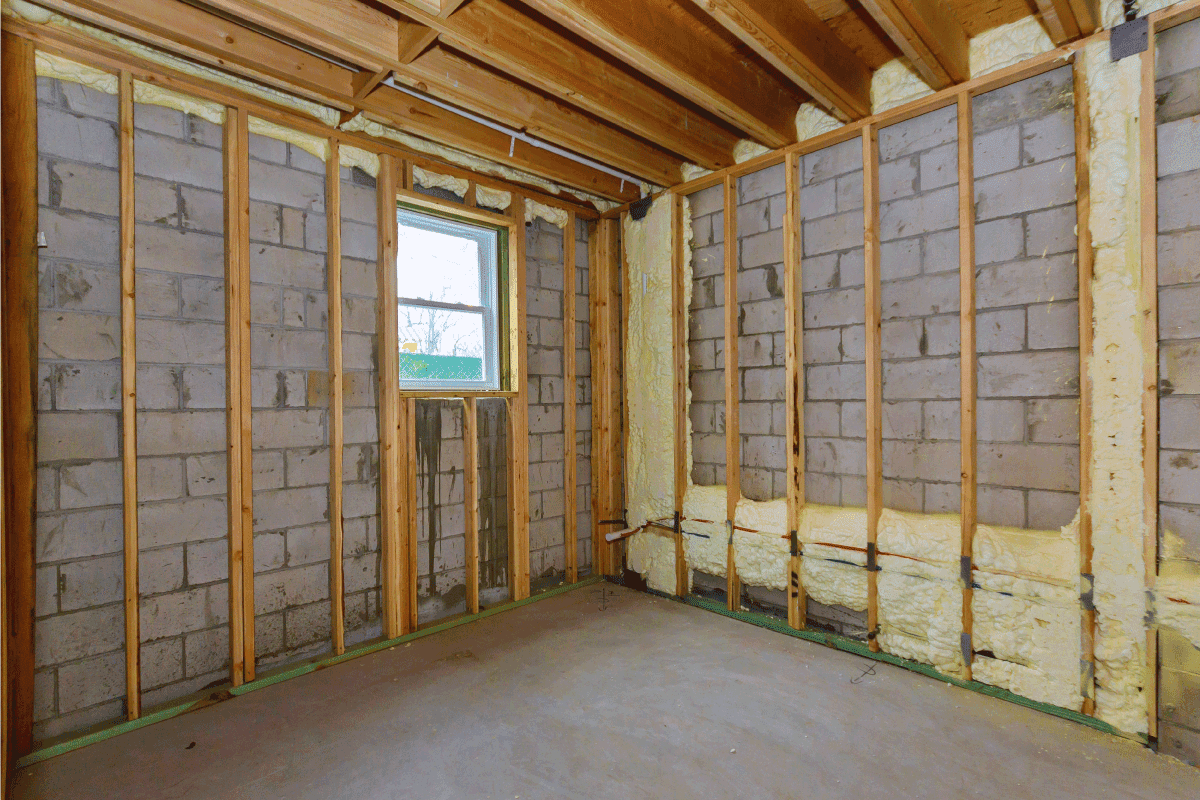 House in unfinished under construction in insulation foam the wall of a basement. Exposed Insulation In Basement—What To Do