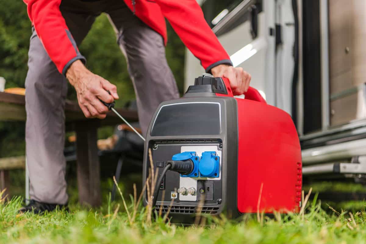 Man turning on a Honda generator for the RV power supply