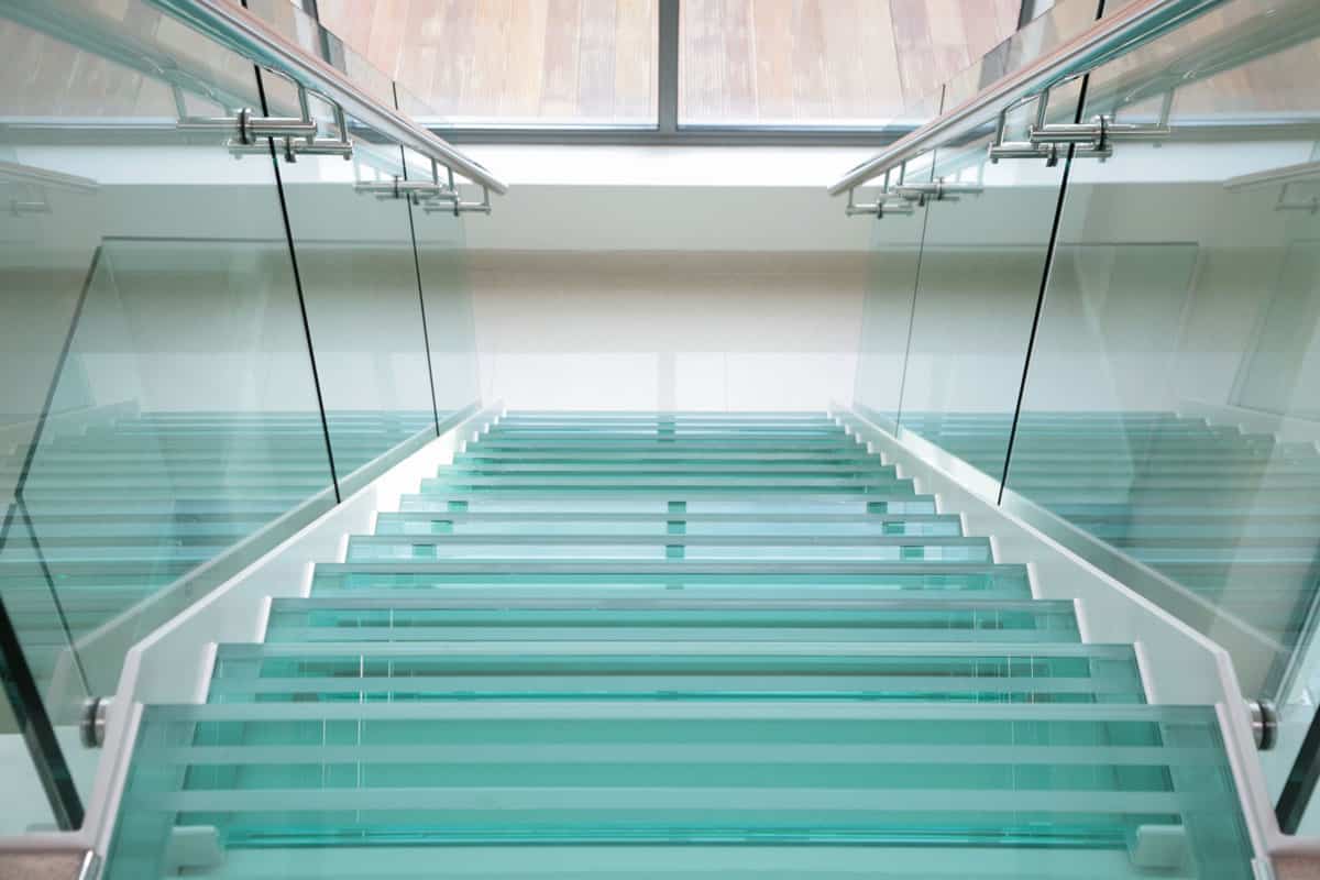 Modern glass stairs in plush new apartment. high key light and airy fee