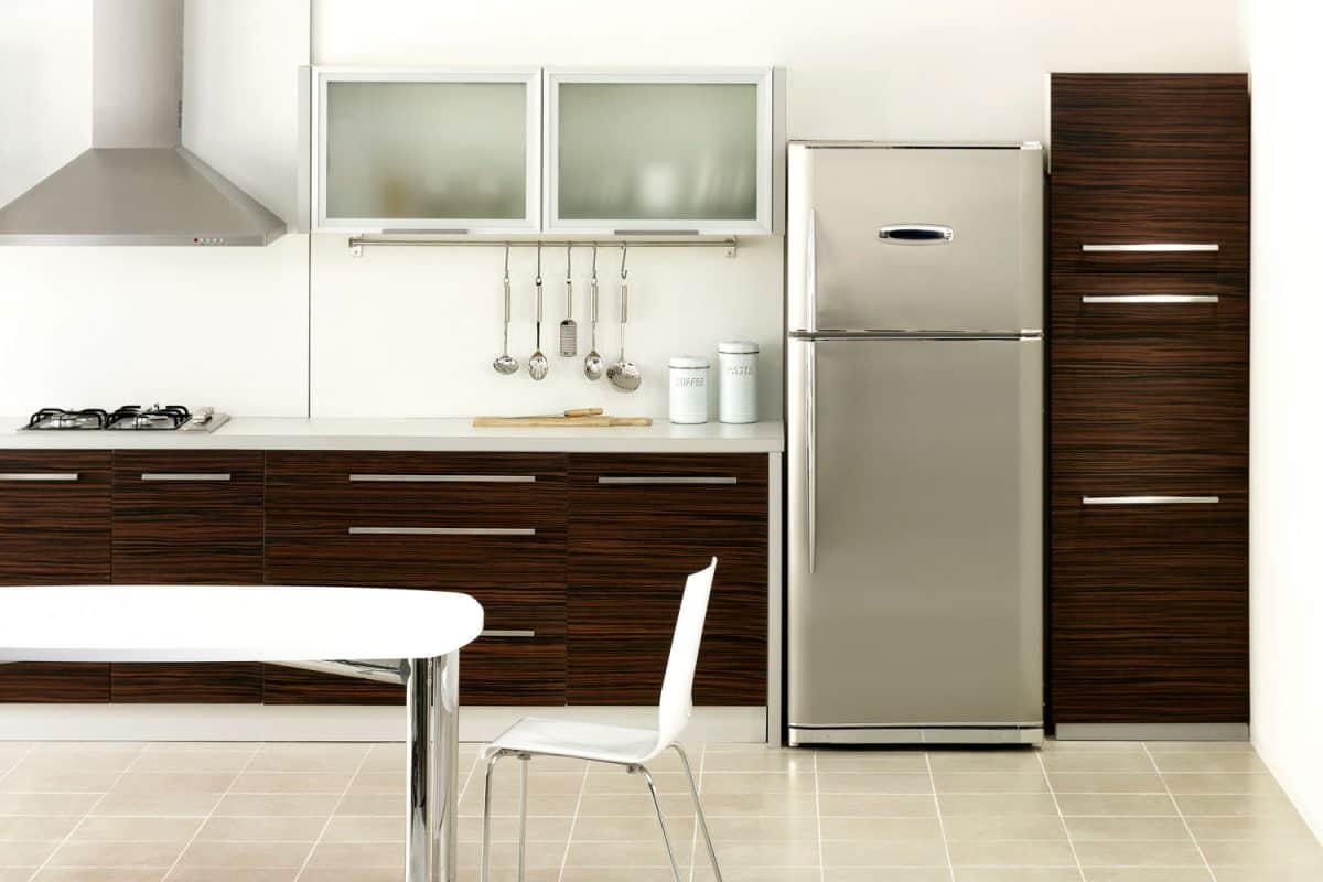 Modern minimalist inspired inspired kitchen with oak cabinets and white backsplash