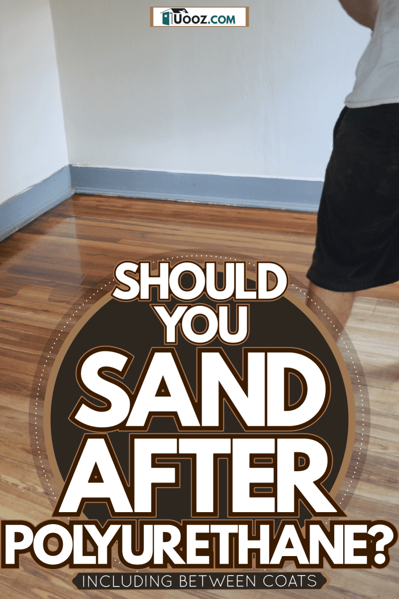 Man applying polyurethane coating on the floor, Should You Sand After Polyurethane? [Inc. Between Coats]