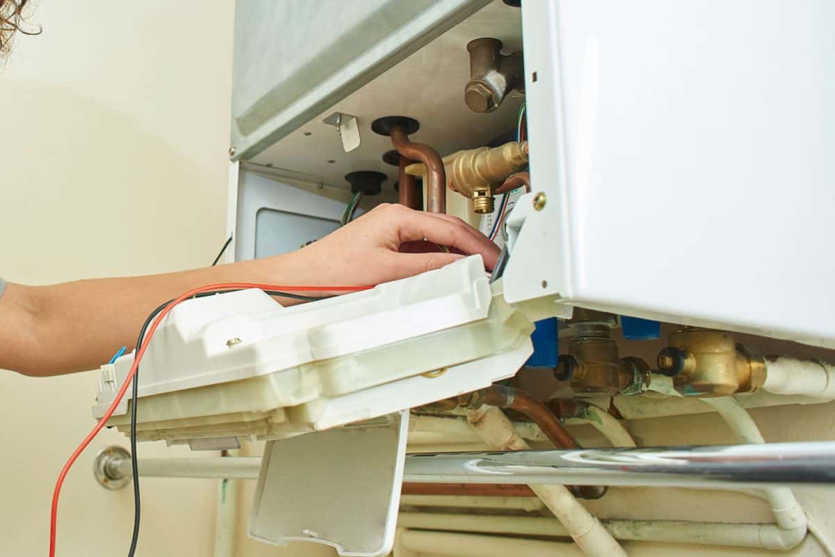 Technician checking the control panel of the gas water heater
