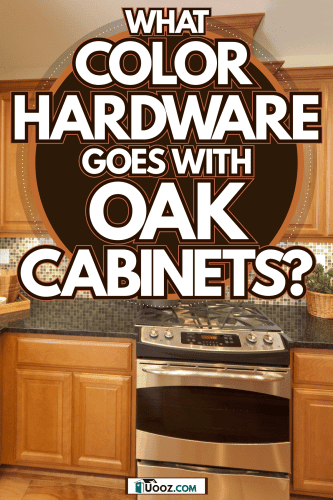 Oak cabinets and cupboard in a rustic kitchen with black marble countertop matched with other oak kitchen utensils, What Color Hardware Goes With Oak Cabinets?