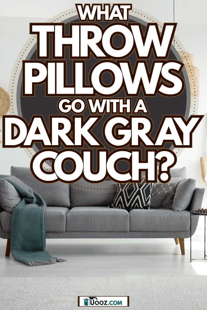 A gray sofa with pattern gray throw pillows inside a minimalist inspired room, What Throw Pillows Go With A Dark Gray Couch?