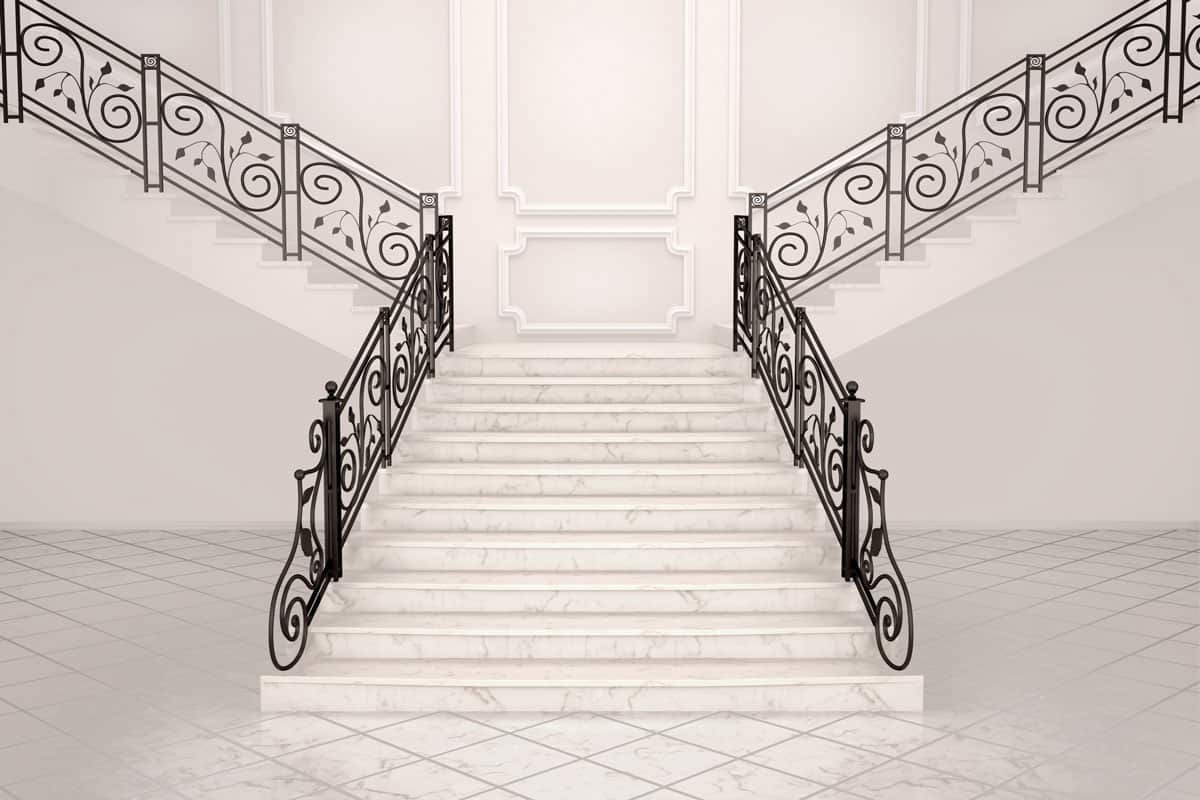 White marble staircase with wrought iron banister