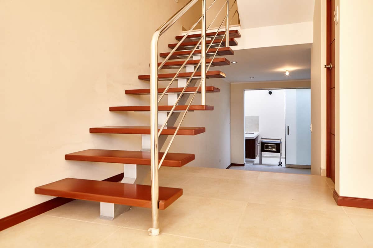 Wood floating stair steps on empty living room
