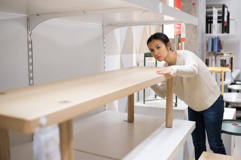 young woman choosing the right furniture for her apartment in a modern home furnishings store, What Comes First: Height, Width Or Length?
