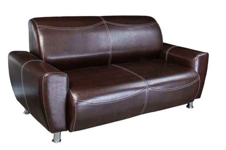 dark artificial leather sofa folded and laid out as a bed isolated on a white background - How To Fix A Peeling Faux Leather Couch