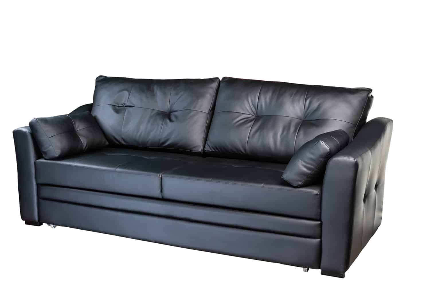 dark artificial leather sofa folded and laid out as a bed isolated on a white background