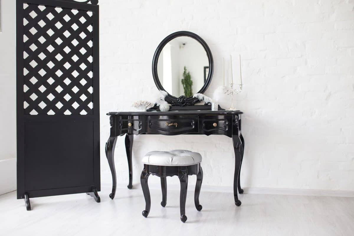 A black classic designed console table with mirror