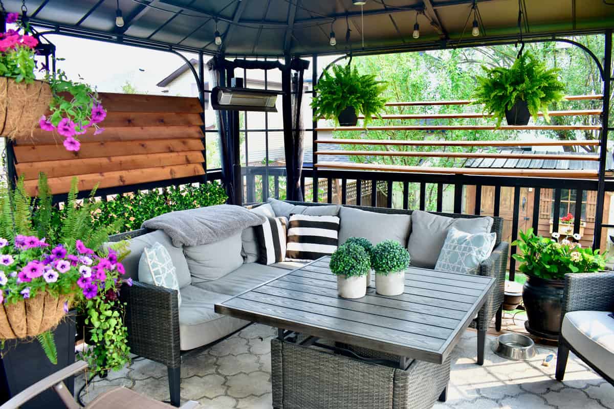 Beautiful seasonal outdoor living room with lush greenery and flowers for spring and summer staycation relaxing