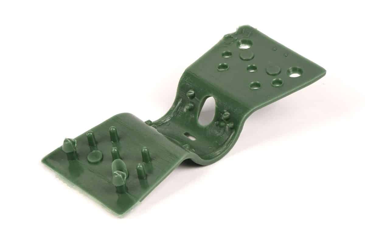 Green tension clips on a white background