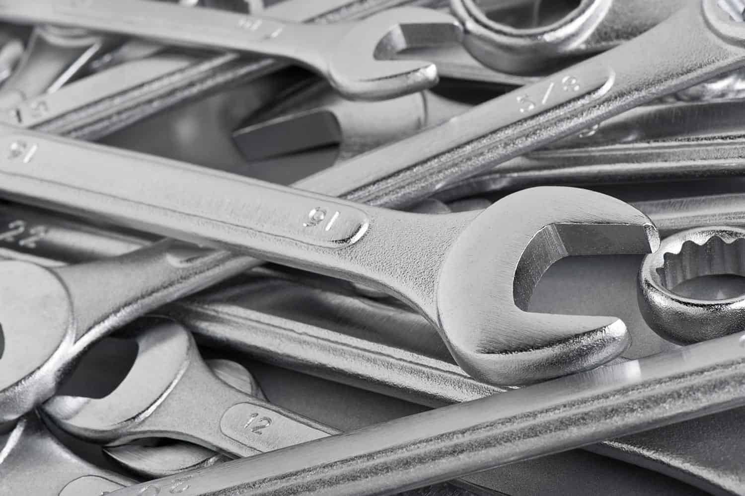 Mixed set of wrenches on a metallic grey table