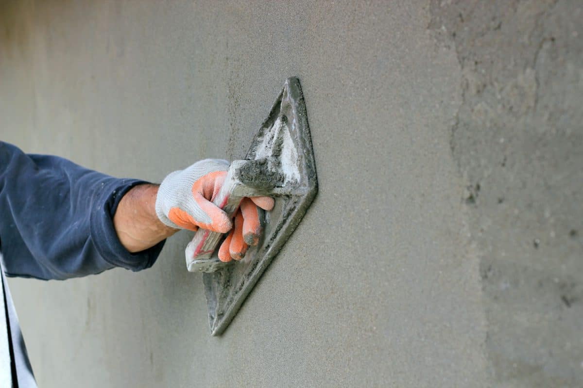 Smoothing out plastering mortar on the house exterior wall