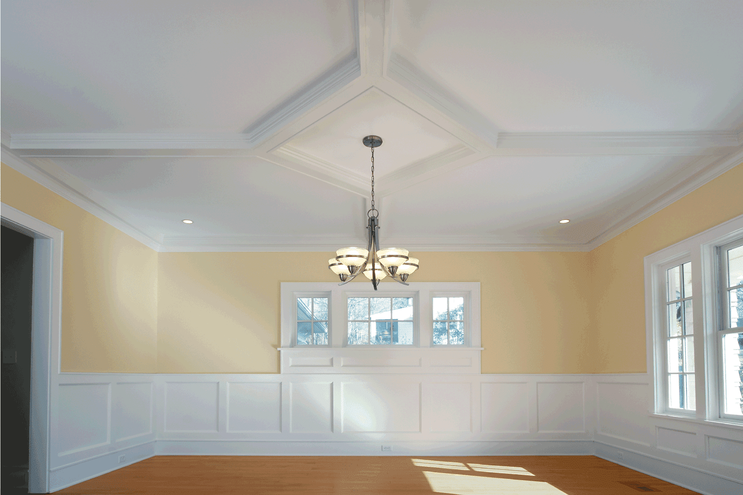The dining room with chandelier in a newly built home.