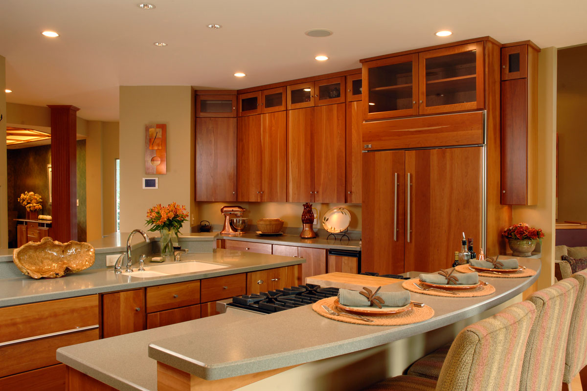 Luxurious rustic inspired kitchen with cherry wood cabinets, marble countertops and beige kitchen utensils