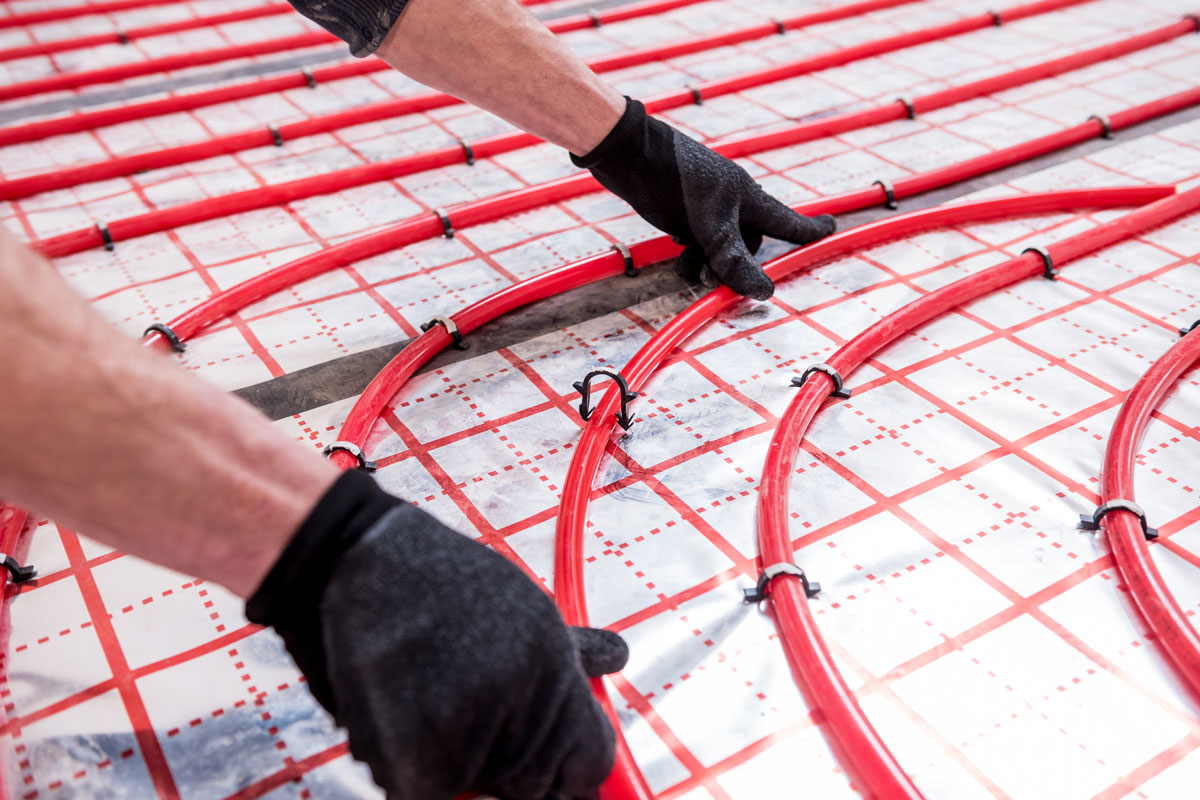 Pipefitter install system of underfloor heating system at home