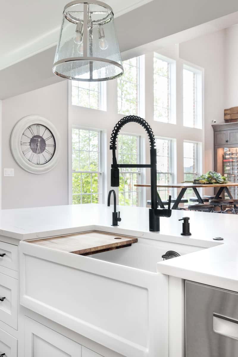 Interior of a white modern kitchen with a Moen faucet