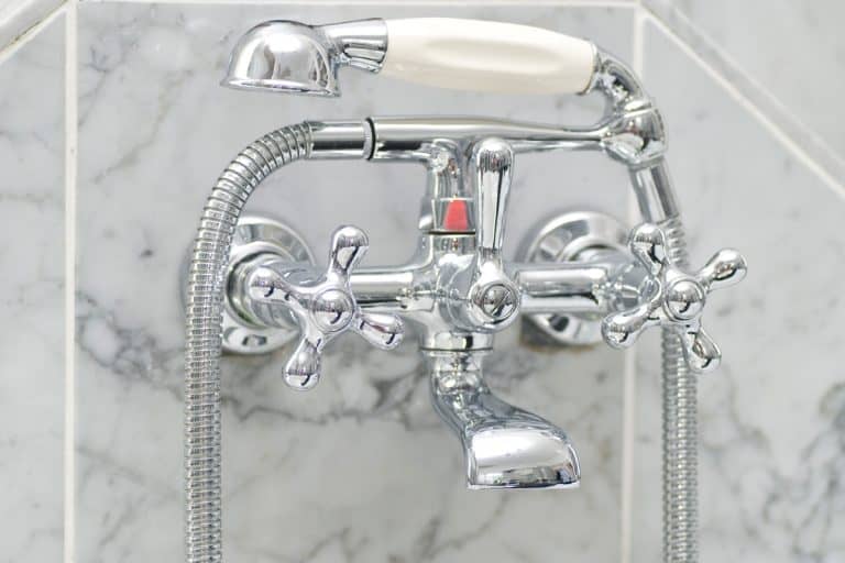 Stainless steel shower head inside a modern bathroom, Can You Have The Shower Head And Valve On Opposite Walls?