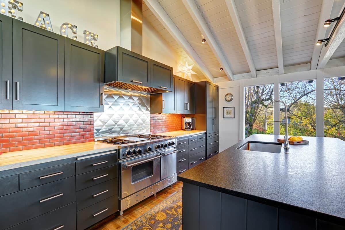 Luxury beautiful dark modern kitchen with vaulted wood ceiling