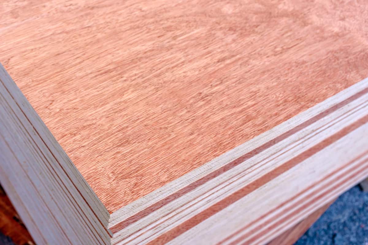 Sheets of stacked plywood in lumberyard. Shallow focus and blurred background.