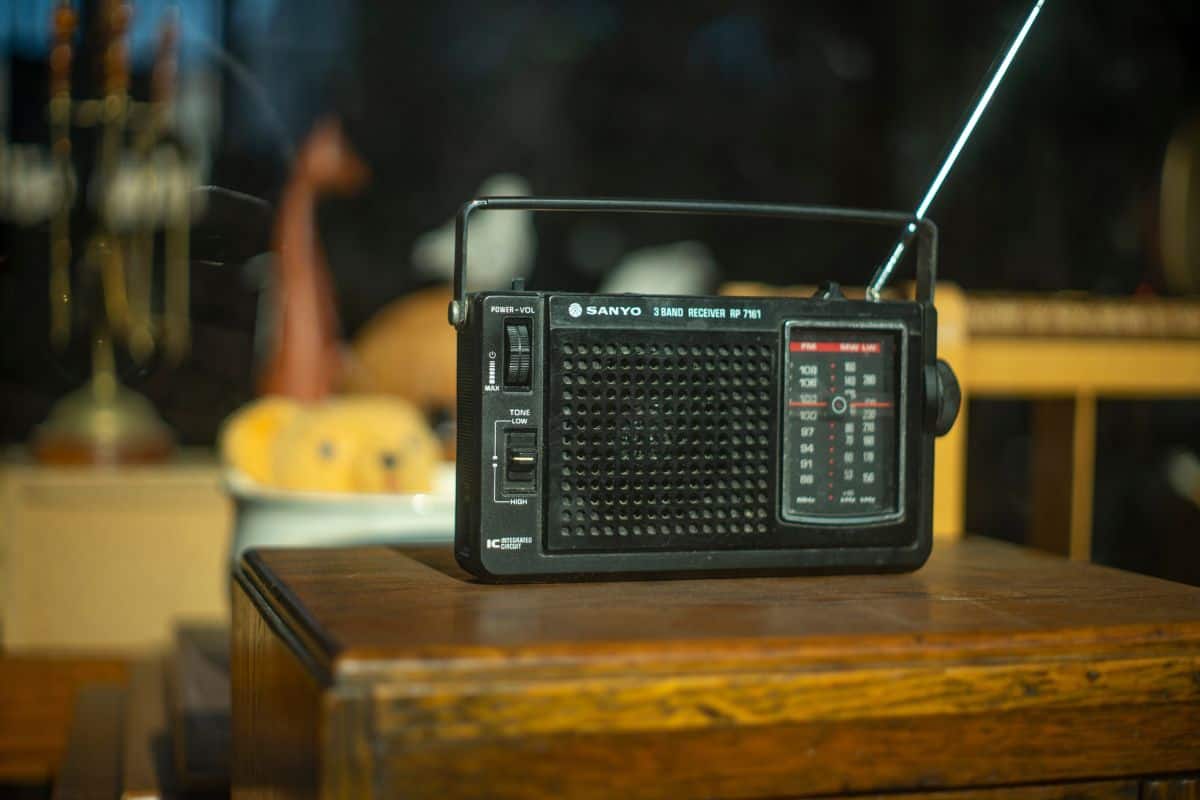 A black analogue Sanyo radio in a shop window.