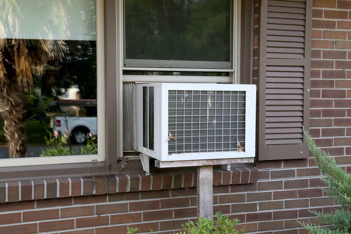 A old window unit air conditioner still being used by people whom don't have central air