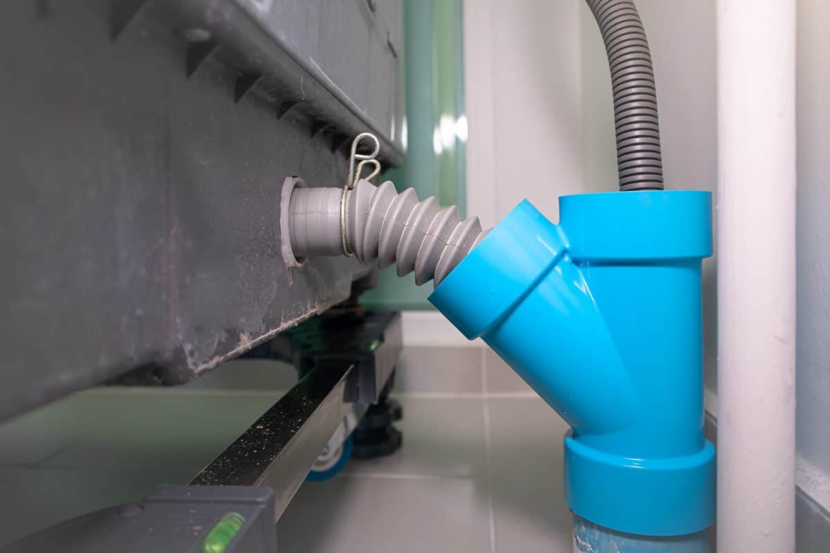 Drain pipe of washing machine connected to a pvc plastic pipe fitting and plastic corrugated flexible hose
