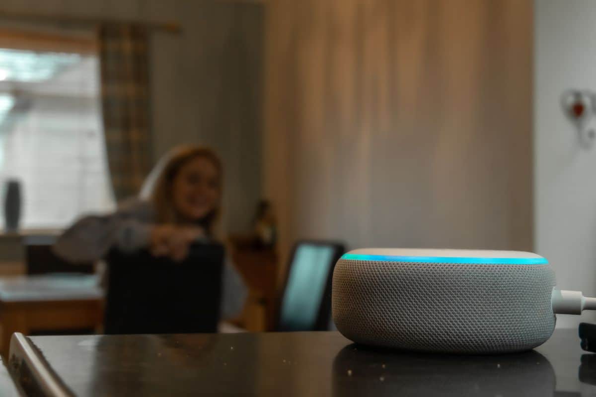 Girl smiling and talking to an Alexa in mosterton on March 2020