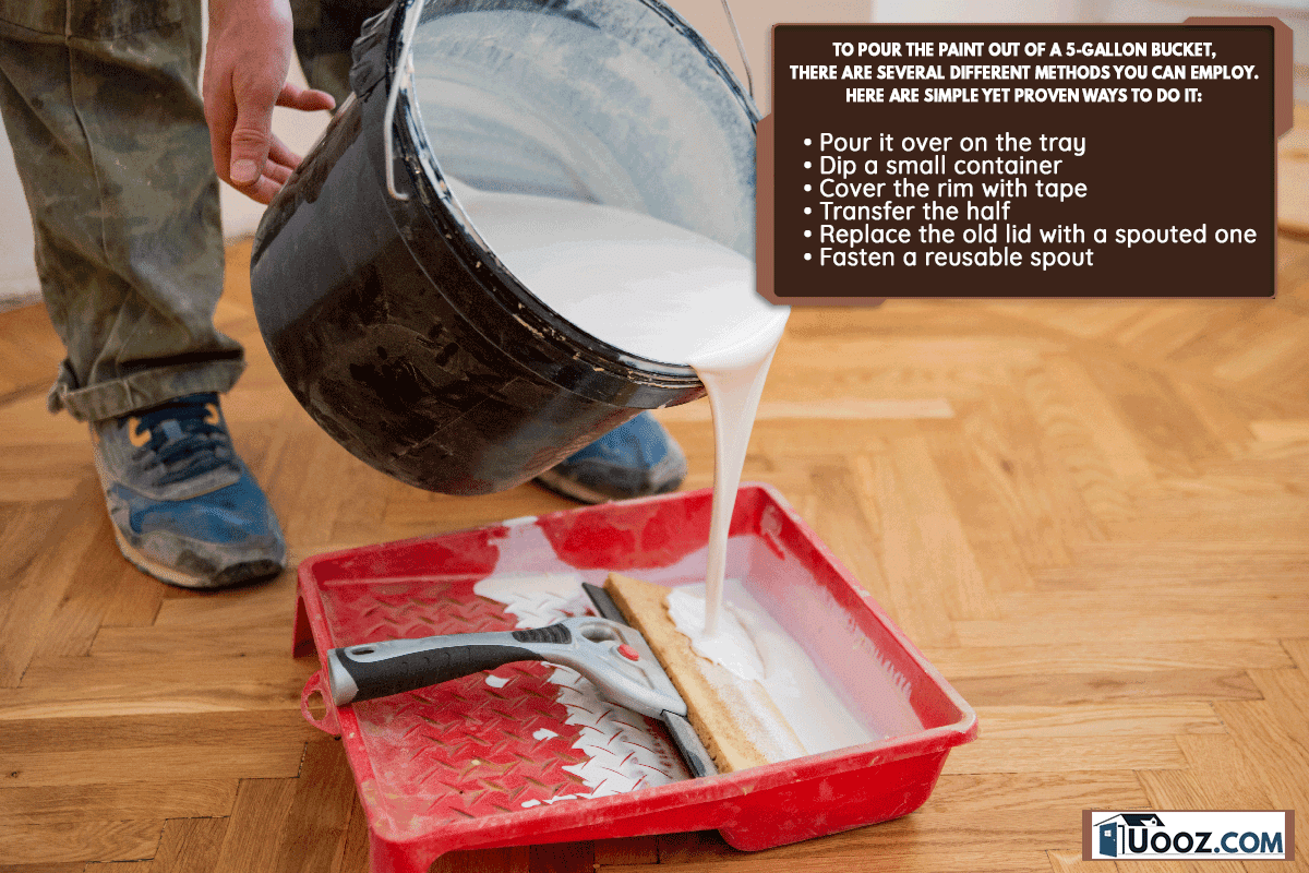 A worker pouring paint for repair into tray, How To Pour Paint Out Of A 5 Gallon Bucket