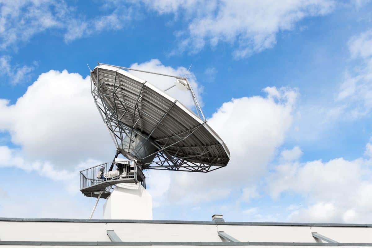 Large satellite communication parabolic dish radar antenna station or astronomical observatory space radio signal telescope against sky