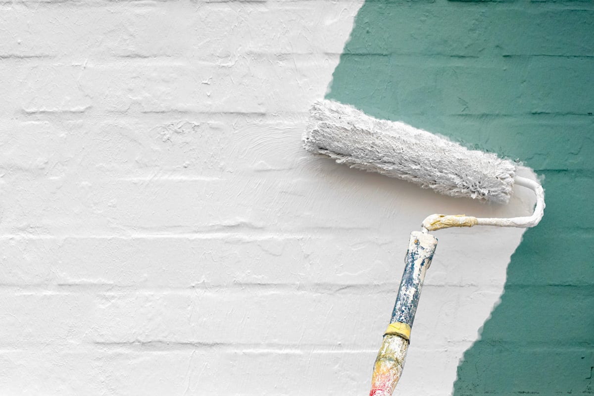 Painting the wall with white paint