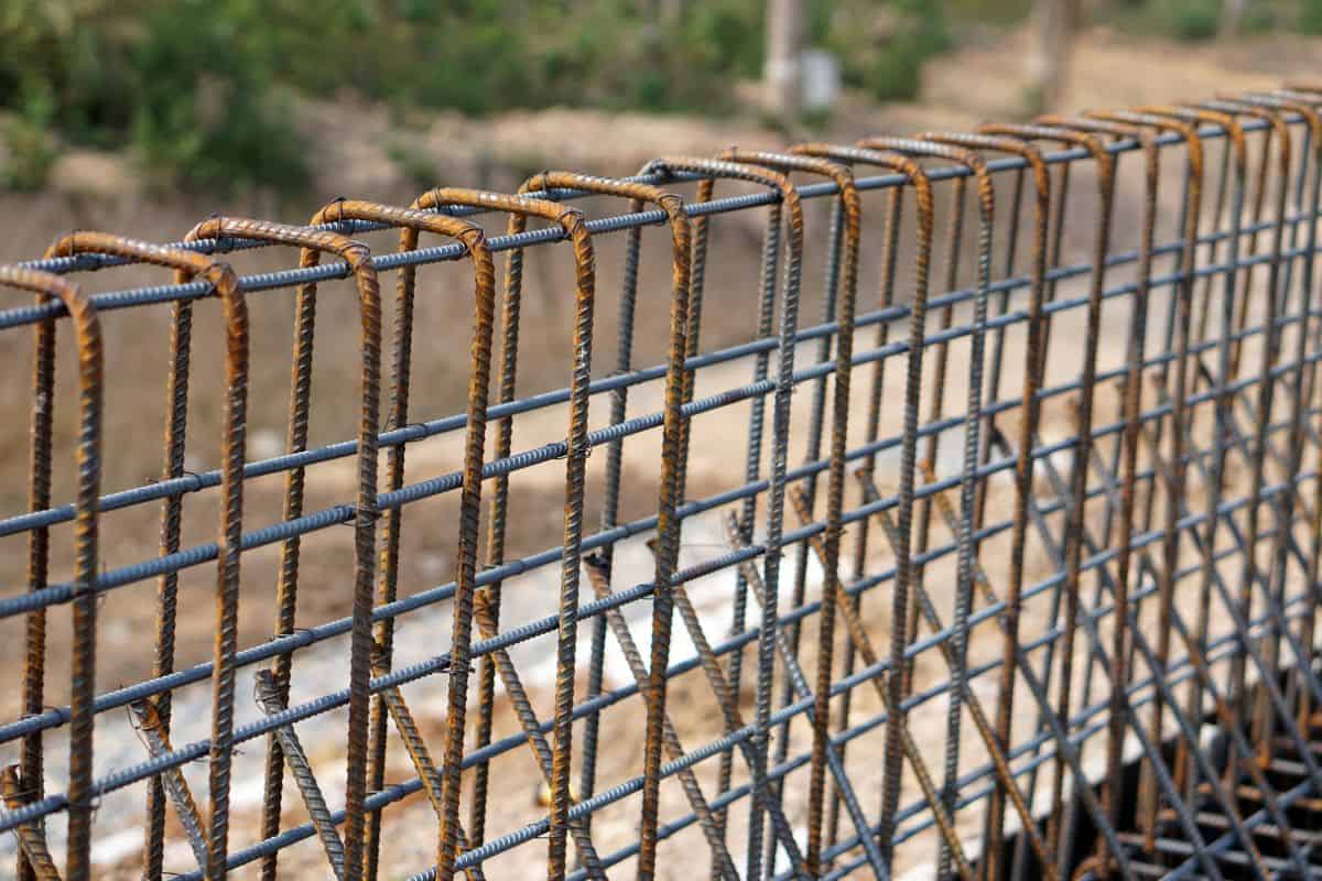 Rebar iron to be used for building foundation of new building at construction site. Wire steel rod to reinforce.