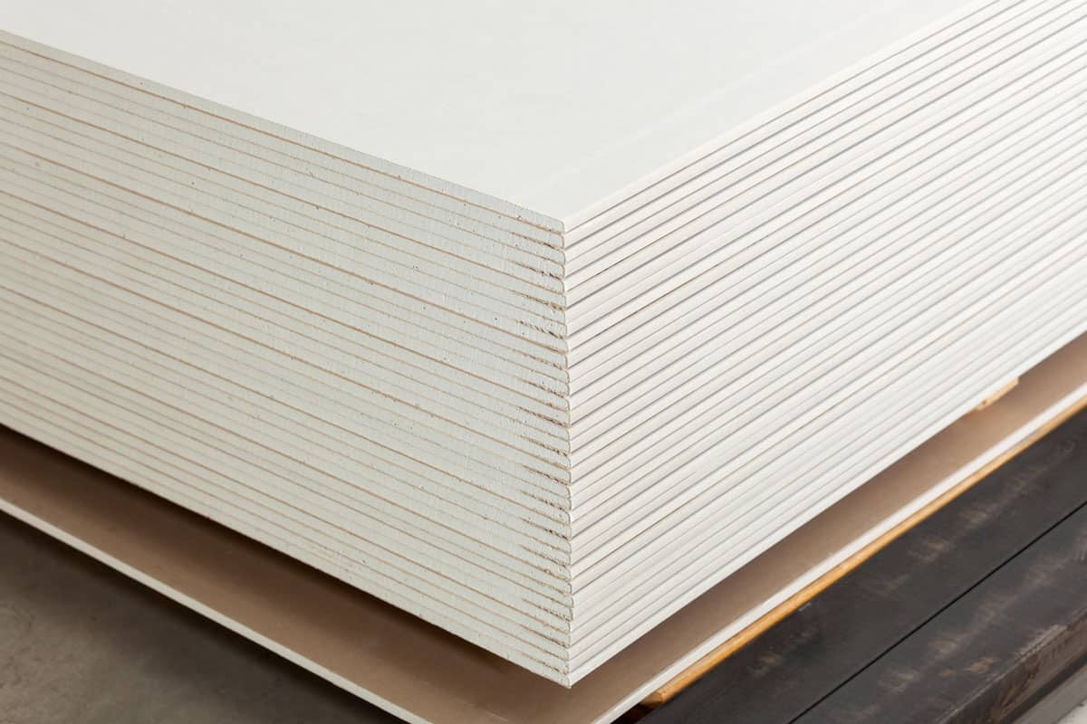 Stacking of white gypsum panels, drywall or plasterboard
