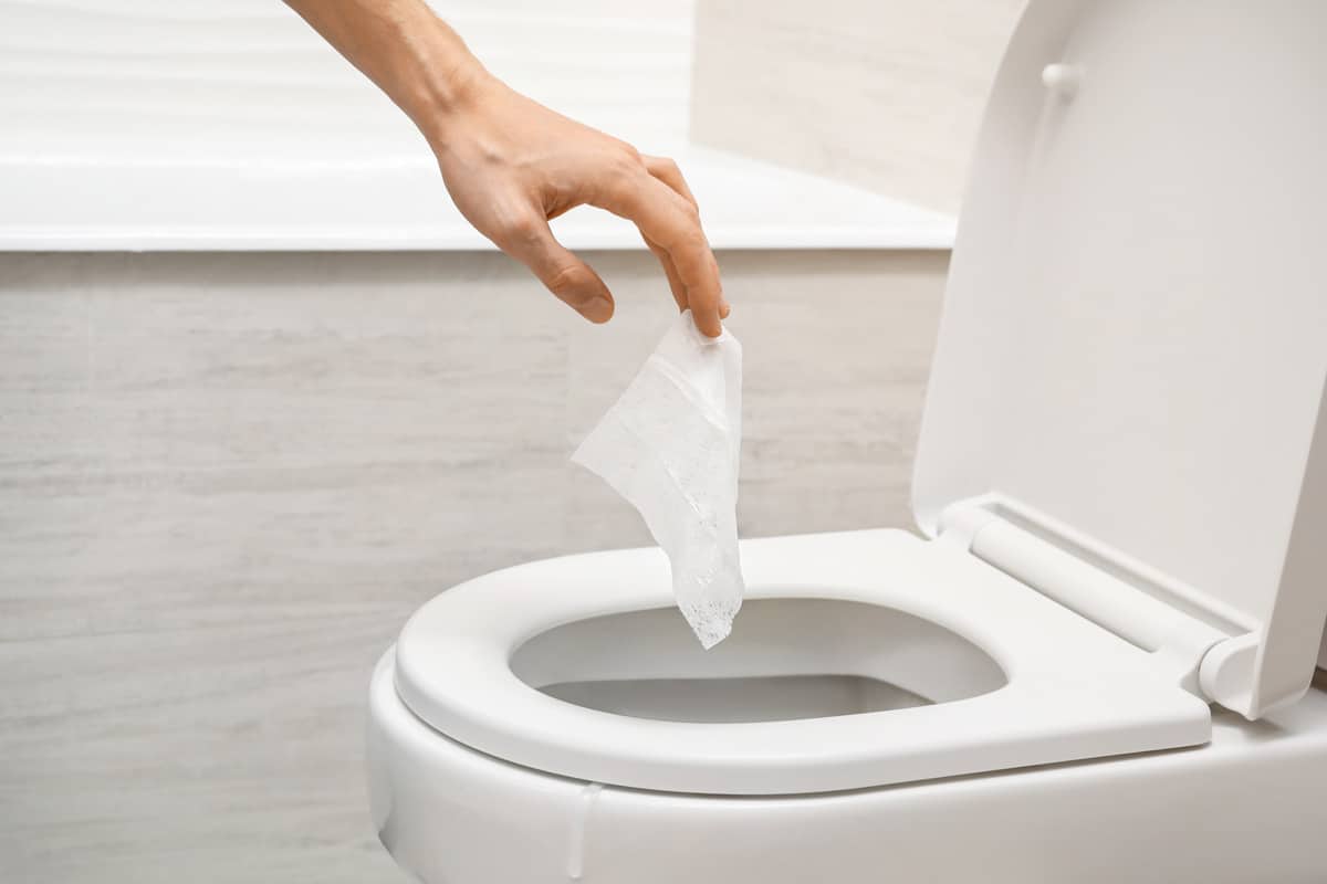 Throwing away a flushable wipe on the toilet