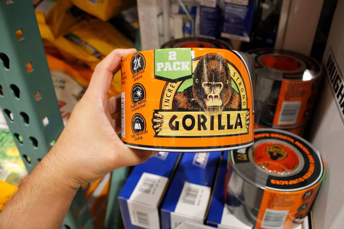 A view of a hand holding a package of Gorilla Tape 2-pack, on display at a local big box grocery store.