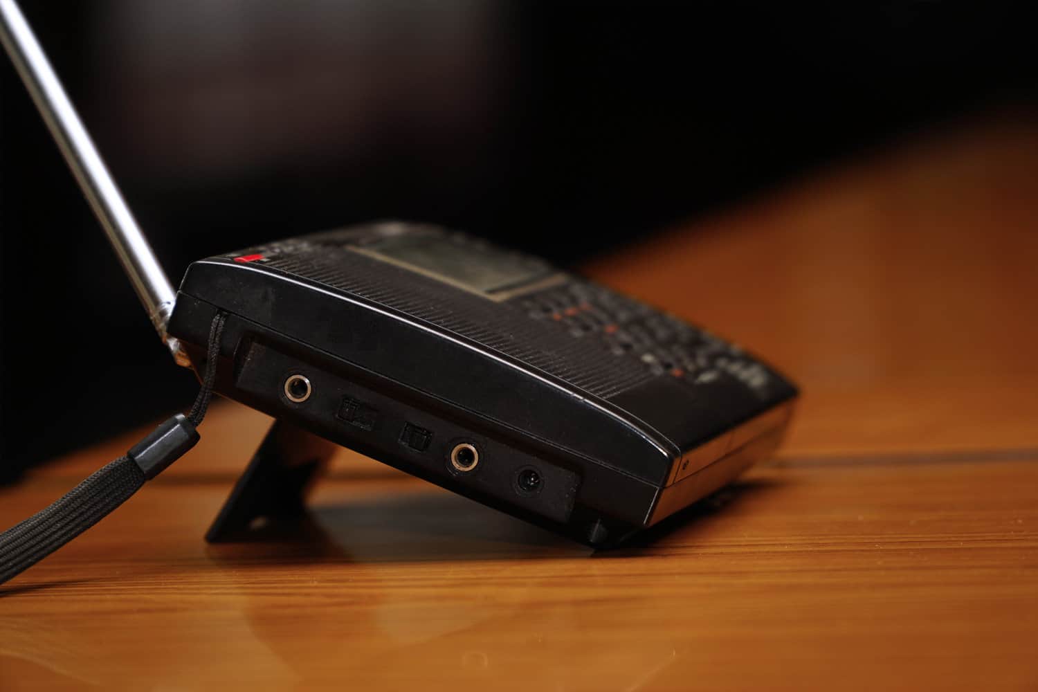 Black analog radio receiver on a wooden table