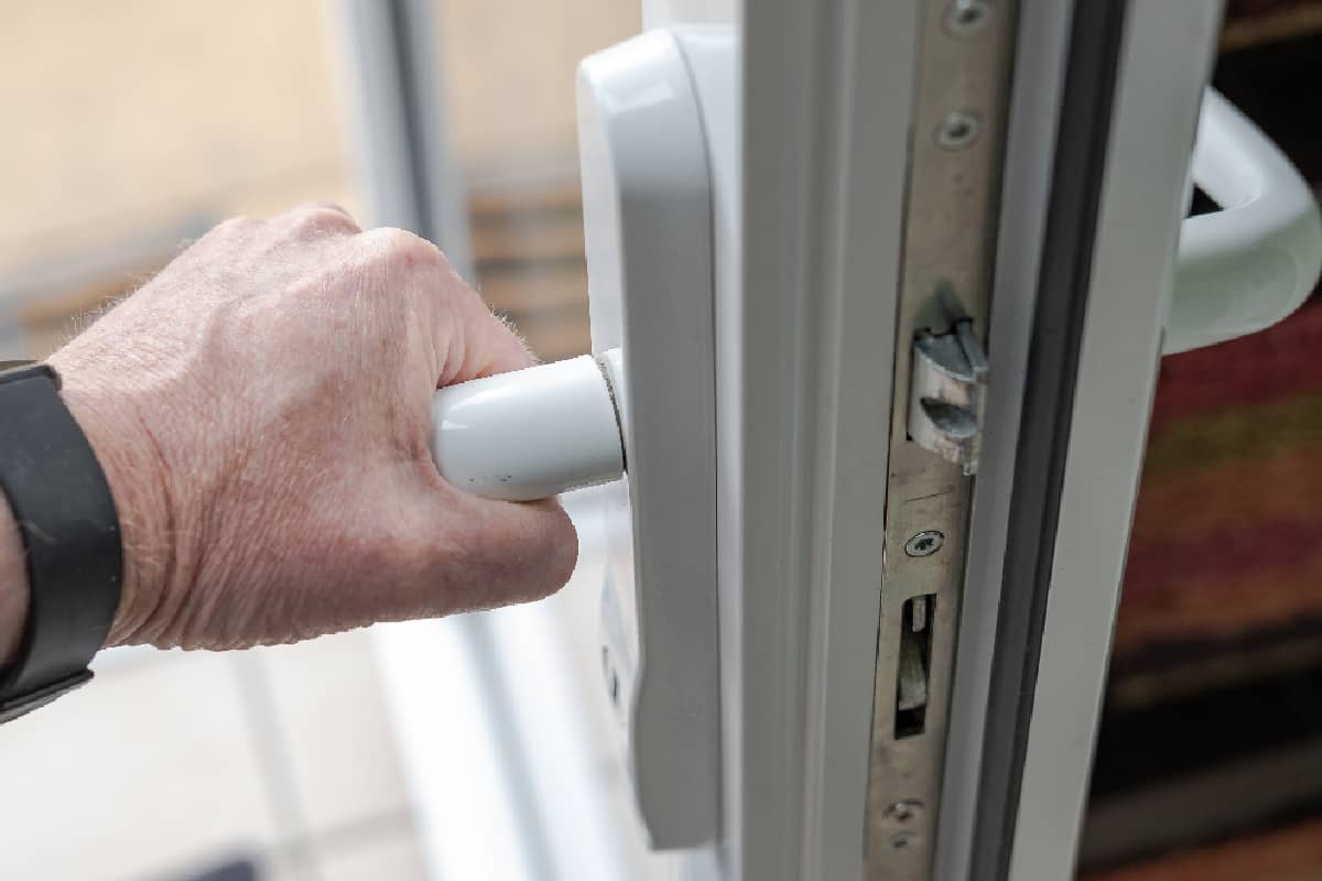 Homeowner seen gripping the handle of a newly installed uPVC high security door
