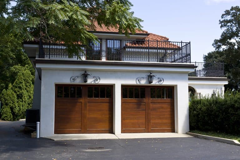 Traditional American garage with dark wooden door, What House Colors Go With Brown Garage Doors?
